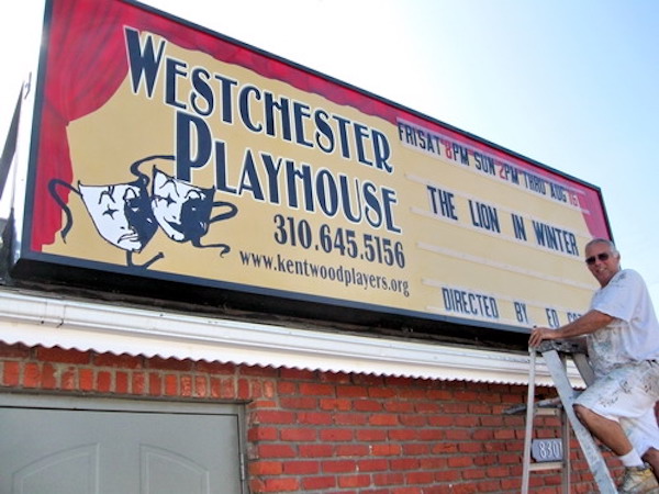 Scot Renfro on a ladder in front of new marquee